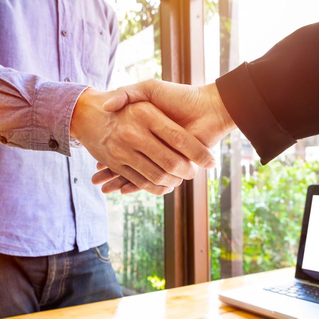 Two business men shaking hands.